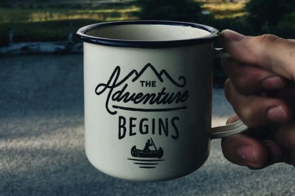 Hand holding Enamel Mug – Mockup