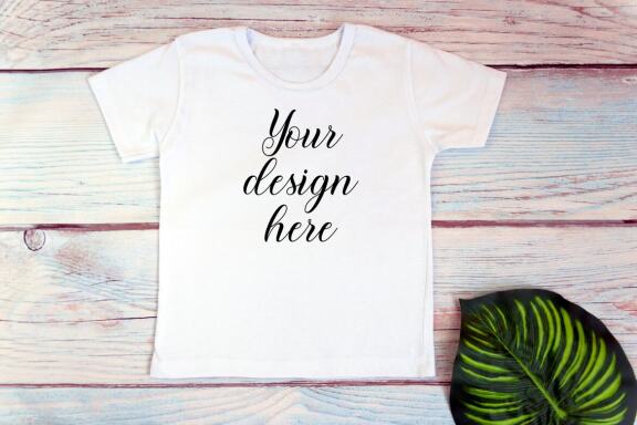 Kids White t-shirt Mockup bundle on a wooden background.
