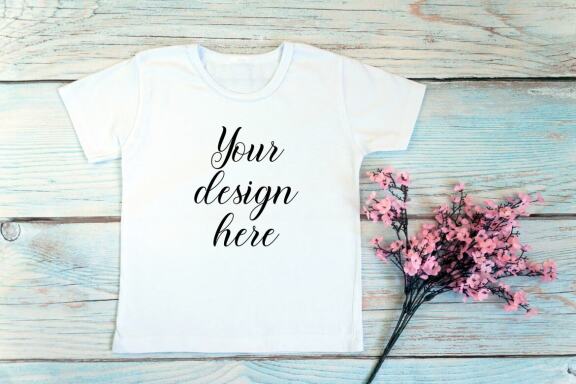 Kids White t-shirt Mockup bundle on a wooden background.
