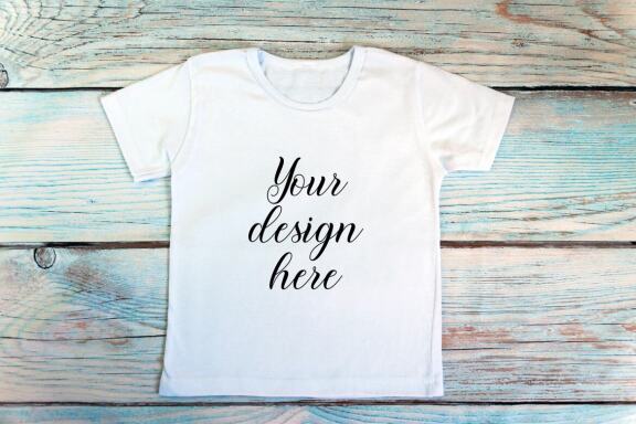 Kids White t-shirt Mockup bundle on a wooden background.