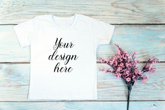 Kids White t-shirt Mockup bundle on a wooden background.