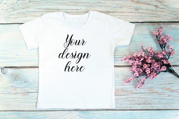 Kids White t-shirt Mockup bundle on a wooden background.