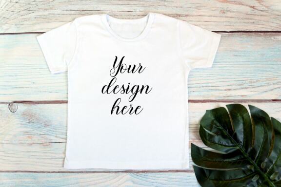 Kids White t-shirt Mockup bundle on a wooden background.
