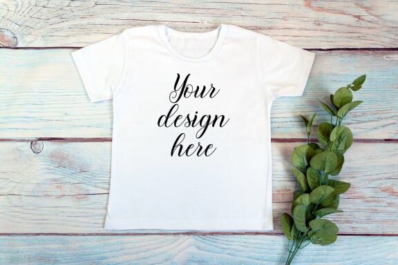 Kids White t-shirt Mockup bundle on a wooden background.