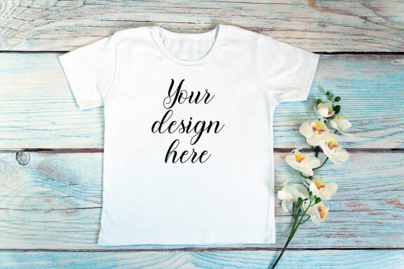 Kids White t-shirt Mockup bundle on a wooden background.