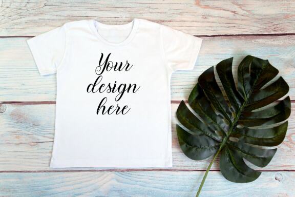 Kids White t-shirt Mockup bundle on a wooden background.