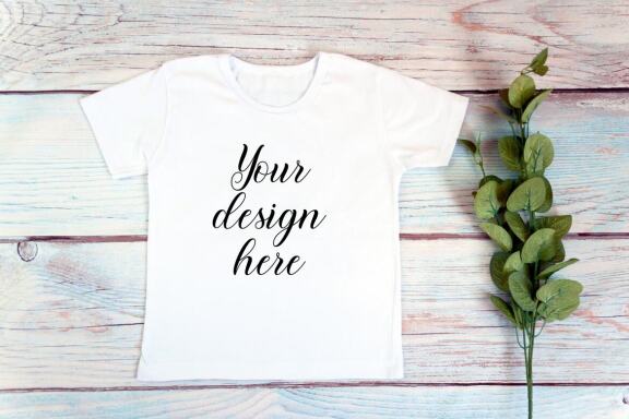 Kids White t-shirt Mockup bundle on a wooden background.