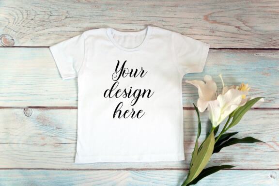 Kids White t-shirt Mockup bundle on a wooden background.
