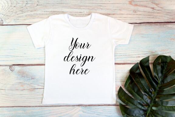 Kids White t-shirt Mockup bundle on a wooden background.
