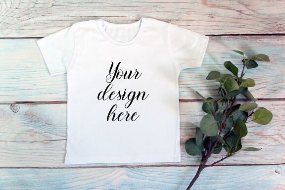 Kids White t-shirt Mockup bundle on a wooden background.
