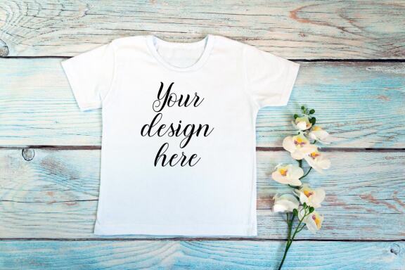 Kids White t-shirt Mockup bundle on a wooden background.