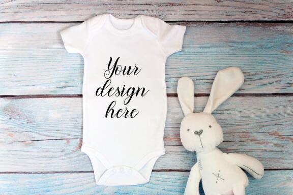 Baby Bodysuit mockup bundle with toys on a wooden background.  Kids T-shirt Mockup. 