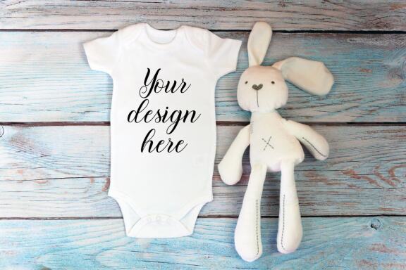Baby Bodysuit mockup bundle with toys on a wooden background.  Kids T-shirt Mockup. 