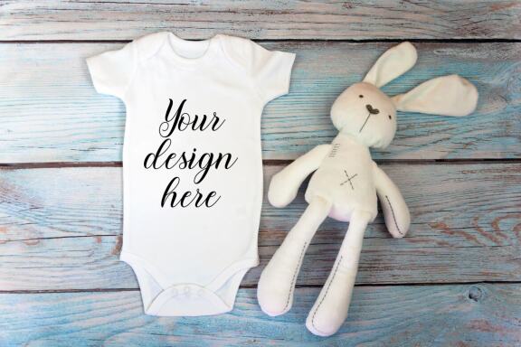 Baby Bodysuit mockup bundle with toys on a wooden background.  Kids T-shirt Mockup. 