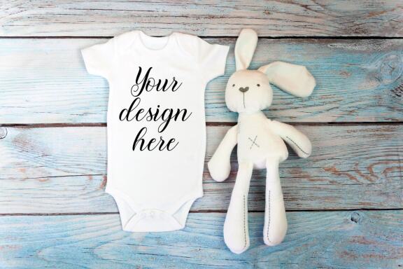 Baby Bodysuit mockup bundle with toys on a wooden background.  Kids T-shirt Mockup. 