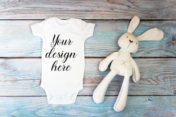 Baby Bodysuit mockup bundle with toys on a wooden background.  Kids T-shirt Mockup. 