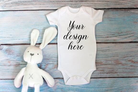 Baby Bodysuit mockup bundle with toys on a wooden background.  Kids T-shirt Mockup. 