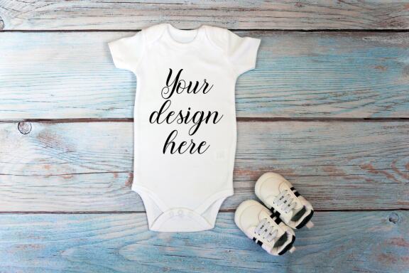 Baby Bodysuit mockup bundle with toys on a wooden background.  Kids T-shirt Mockup. 