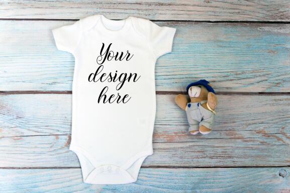 Baby Bodysuit mockup bundle with toys on a wooden background.  Kids T-shirt Mockup. 