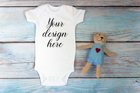 Baby Bodysuit mockup bundle with toys on a wooden background.  Kids T-shirt Mockup. 