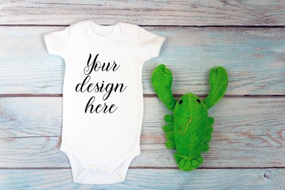 Baby Bodysuit mockup bundle with toys on a wooden background.  Kids T-shirt Mockup. 
