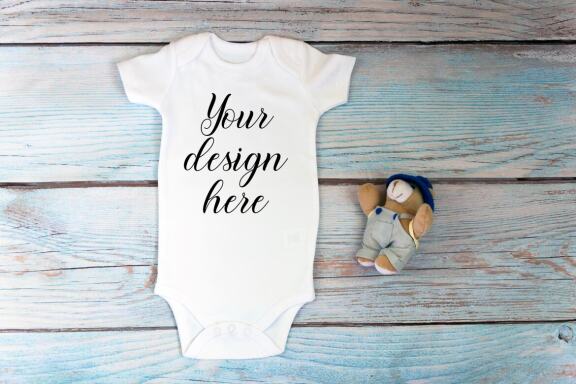 Baby Bodysuit mockup bundle with toys on a wooden background.  Kids T-shirt Mockup. 