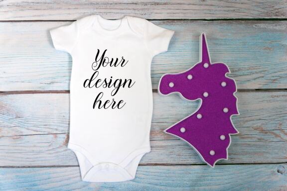 Baby Bodysuit mockup bundle with toys on a wooden background.  Kids T-shirt Mockup. 