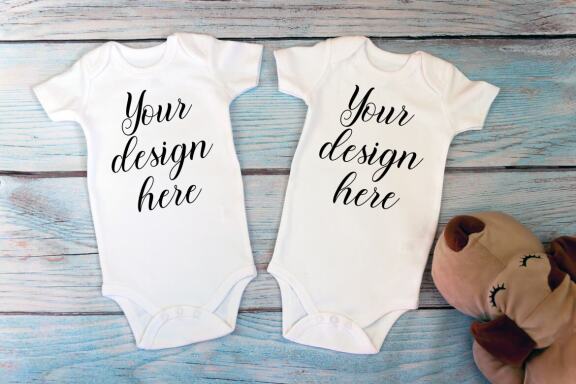 Kids Mockup Bundle of two baby bodysuits with toys. Twin baby bodysuit mockup. Kids Mockup Bundle.