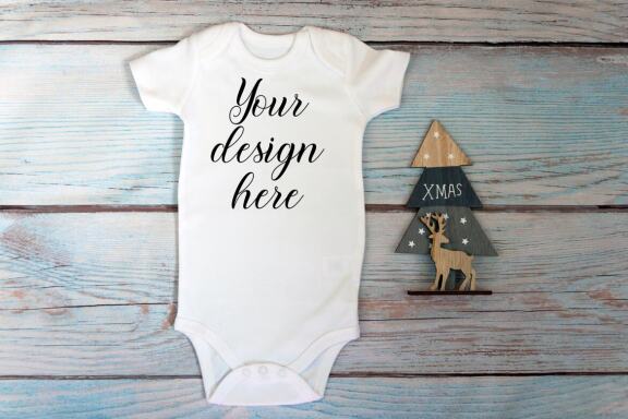 Christmas t-shirts and bodysuits mockups Bundle on a wooden background. Winter Christmas styled photo mockup.