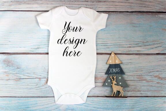 Christmas t-shirts and bodysuits mockups Bundle on a wooden background. Winter Christmas styled photo mockup.