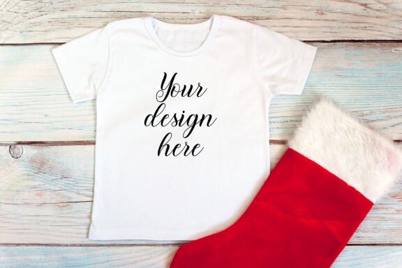 Christmas t-shirts and bodysuits mockups Bundle on a wooden background. Winter Christmas styled photo mockup.