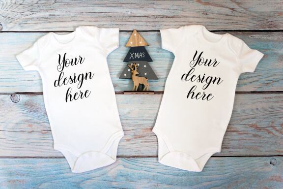 Christmas t-shirts and bodysuits mockups Bundle on a wooden background. Winter Christmas styled photo mockup.