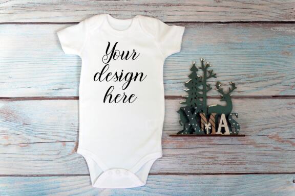 Christmas t-shirts and bodysuits mockups Bundle on a wooden background. Winter Christmas styled photo mockup.
