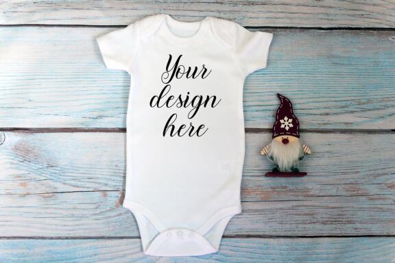 Christmas t-shirts and bodysuits mockups Bundle on a wooden background. Winter Christmas styled photo mockup.
