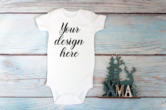 Christmas t-shirts and bodysuits mockups Bundle on a wooden background. Winter Christmas styled photo mockup.