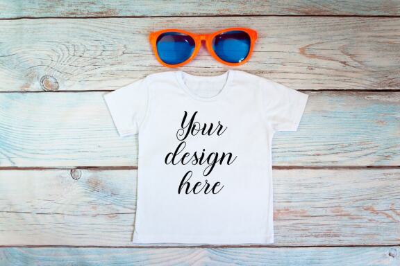 White kid t-shirt mockup bundle. T-shirt on a wooden background.