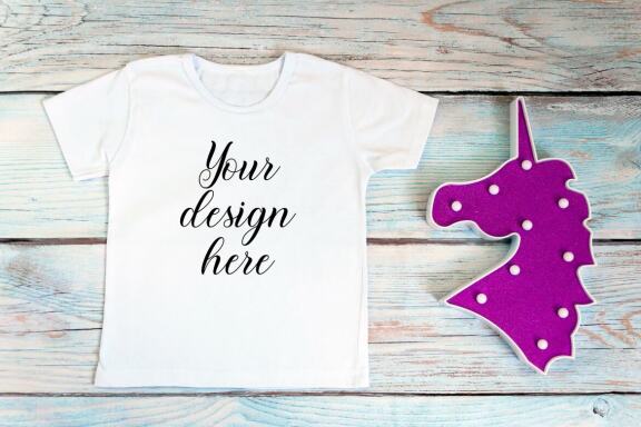 White kid t-shirt mockup bundle. T-shirt on a wooden background.