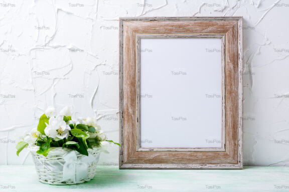 Wooden picture frame mockup with apple tree flowers.
