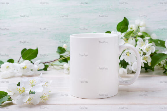 White coffee mug mockup with tender apple blossom.