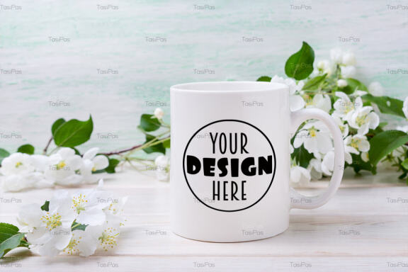 White coffee mug mockup with tender apple blossom.
