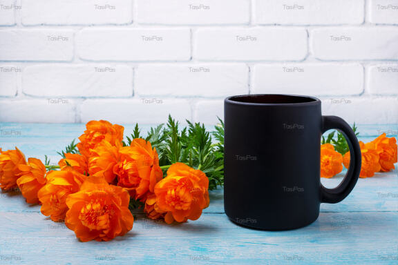 Black coffee mug mockup with wild globeflowers.