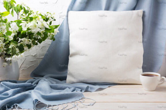 Pillow mockup with apple blossom branches and blue scarf.