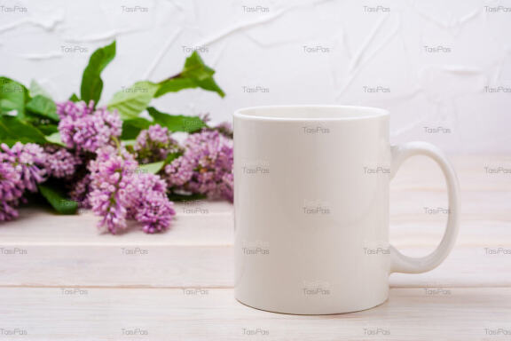 White coffee mug mockup with lilac near painted wall.