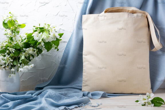 Rustic tote bag mockup with apple blossom in the vase.