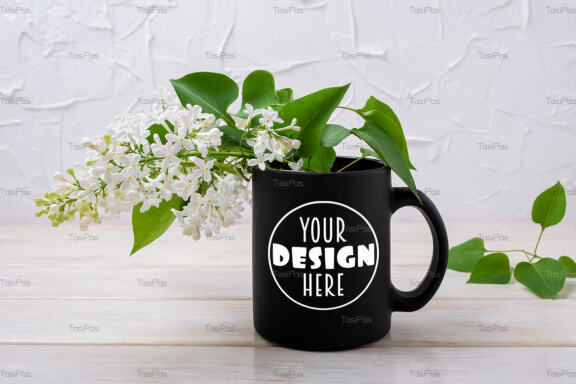 Black coffee mug mockup with blooming white lilac.