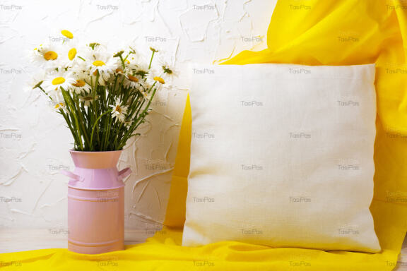 Pillow mockup with daisy flowers and yellow scarf.
